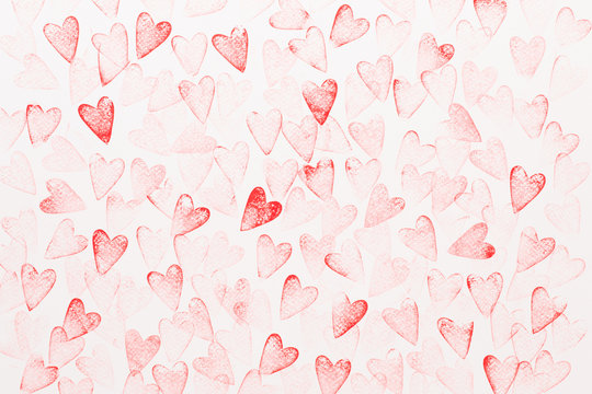 A pattern of red, hand-drawn hearts is scattered densely across a white background, creating a romantic and playful design.